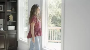 Woman looking at patio door