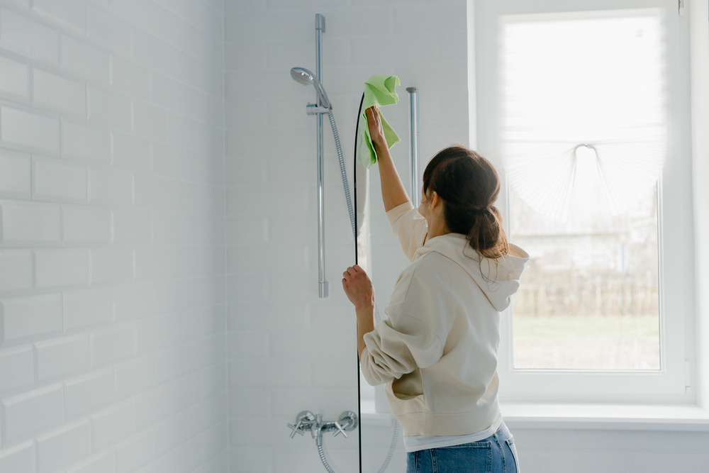 Woman Cleaning Walk-in Shower